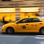 tilt shift photography of yellow taxi car